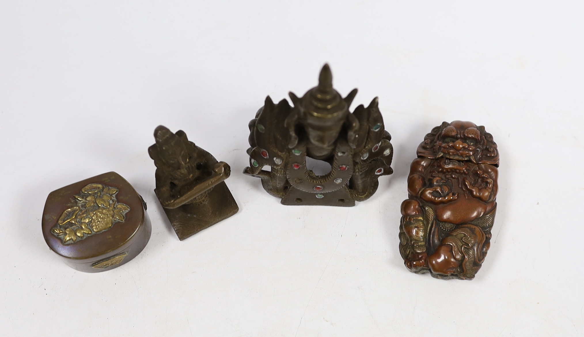 A Japanese mixed metal Vesta case modelled as an oni, a similar box, a Thai bronze figure and an Indian brass figure (4)